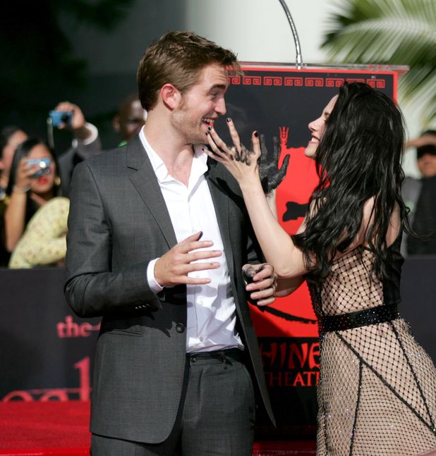 The couple having flirty fun at a hand and foot print ceremony