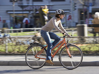 Woman on bicycle cycling through town