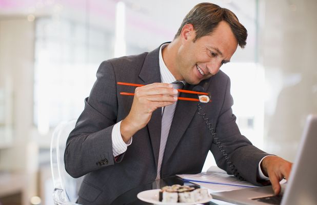 Office worker eating lunch at desk