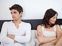 Couple in bed looking annoyed and not speaking to one another