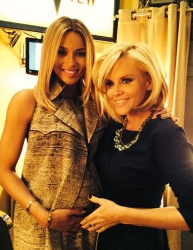 A pregnant Ciara poses with The View co-host Jenny McCarthy after confirming her pregnancy on The View, 14 January 2014